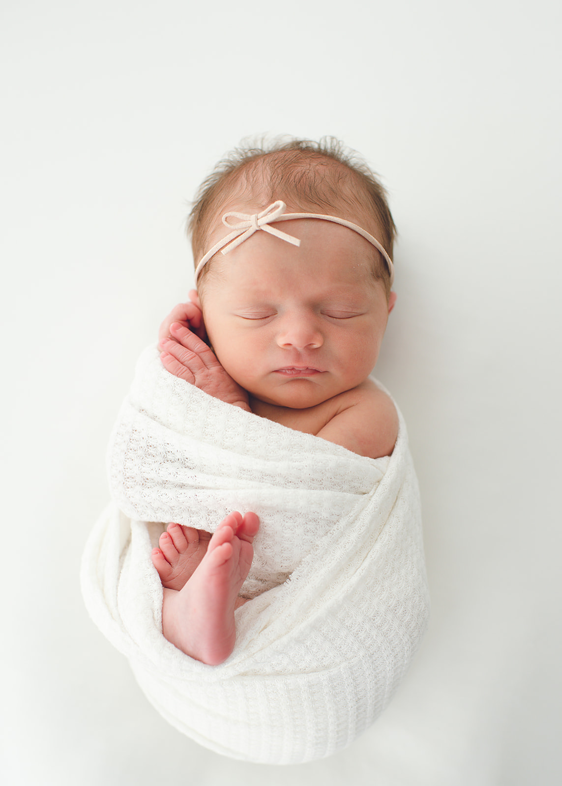 Newborn baby wrapped for photoshoot